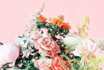 Bouquet of gerbera, roses and carnations on pink background.