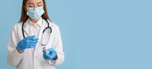 Female doctor holding monkeypox vaccine and syringe on blue background with space for text