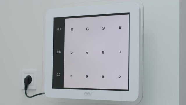 Snellen chart testing vision Black numbers on a white surface laid on white background