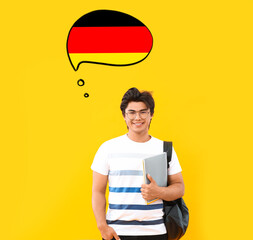 Portrait of handsome Asian student on yellow background. Concept of speaking German