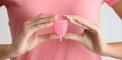 Woman holding menstrual cup, closeup
