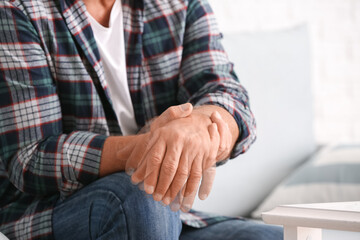 Obraz na płótnie Canvas Mature man with Parkinson syndrome at home, closeup