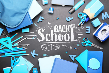 Set of supplies and written text BACK TO SCHOOL on blackboard