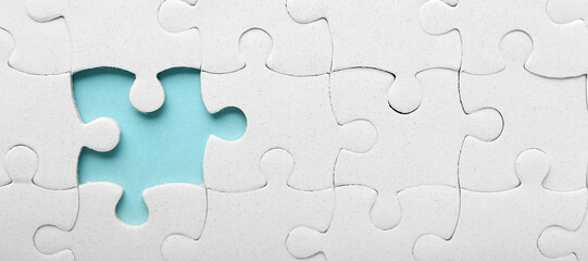 White jigsaw puzzle with missing piece, top view