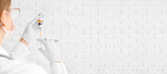 Female doctor with monkeypox vaccine and syringe on white background with space for text