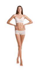 Naklejka premium Young tanned woman in underwear on white background
