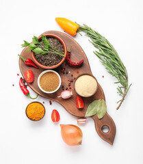 Wooden board with spices, vegetables and herbs on white background