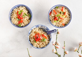 Bowl of tasty noodles on light background