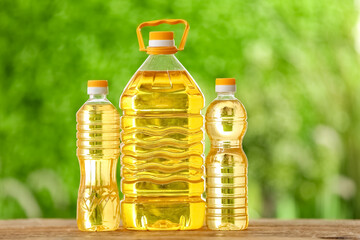 Bottles of sunflower oil on table outdoors