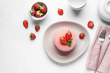 Composition with pink pancakes and strawberry on light background