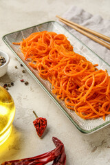 Bowl of aromatic korean carrot salad on table, closeup
