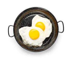 Frying pan with eggs isolated on white background