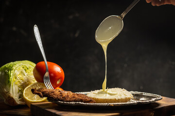 jars of mayonnaise or milk cream falling in backlight