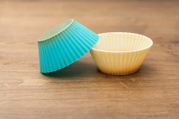 group of colored silicone molds for cupcake, in white, purple and blue colors