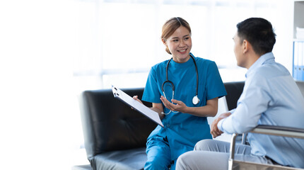 Fototapeta premium Doctor and patient sitting and talking at medical examination at hospital office, close-up. Therapist filling up medication history records. Medicine and healthcare concept.