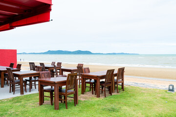 wood table and chair with sea beach background