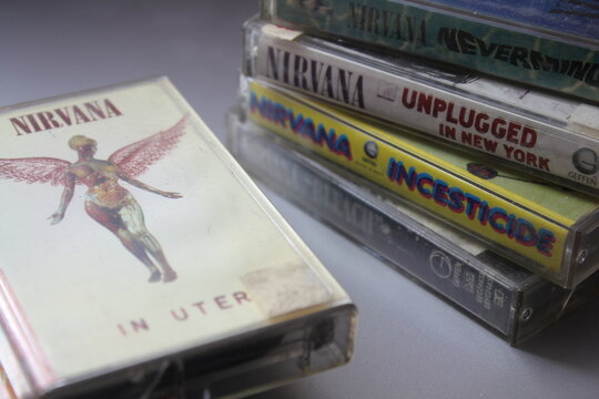 Bangkok, Thailand - february ,09 2022 : 90's cassette tapes of Nirvana Albums Incesticide, Nevermind, Bleach, From The Muddy Banks of The Wishkah, Unplugged in New York on a gray floor.