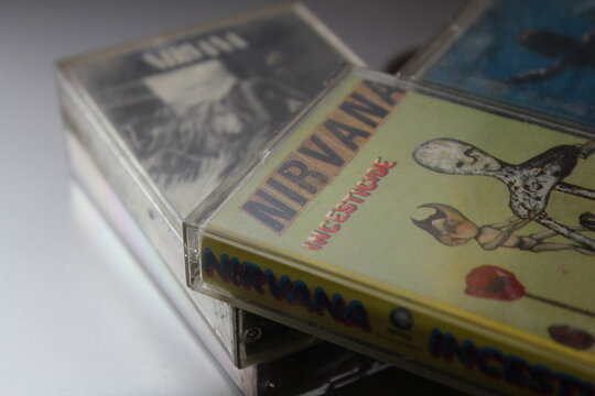Bangkok, Thailand - february ,09 2022 : 90's cassette tapes of Nirvana Albums Incesticide, Nevermind, Bleach, From The Muddy Banks of The Wishkah, Unplugged in New York on a gray floor.