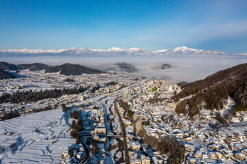 Fototapeta na wymiar Misty Valley in Nagano Japan, Winter Covering Yamanouchi and Jigokudani