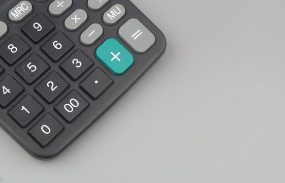 Black calculator on grey background with room for text.