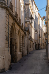 Scenic urban landscape of typical narrow street with ancient buildings in the historic center of Montpellier, France