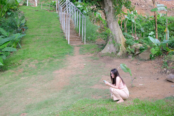 Funny girl using smart phone while sitting on ground