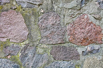 An old stone wall covered with mold.