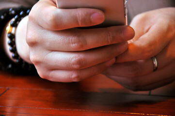 Holding and touching on mobile phone with silver screen