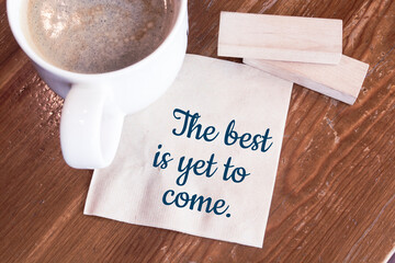 The best is yet to come - handwriting on a napkin with a cup of espresso coffee