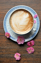 cup of coffee and plum flowers on the table