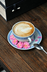 cup of coffee and plum flowers on the table