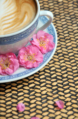 cup of coffee and plum flowers on the table