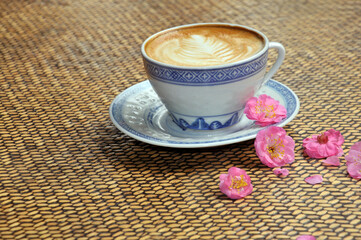 cup of coffee and plum flowers on the table
