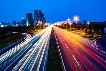 Long-exposure shot of a highway illuminated with colorful lights