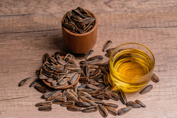 Sunflower oil in a glass cup and dried sunflower seeds