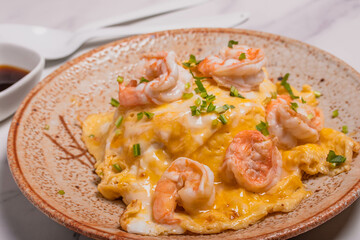 Creamy omelette with shrimps on rice served fish sauce, Thai style