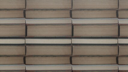 Wall with stacked books. Books one on top of the other with pastes and sheets of paper. Stacked old books. Book pattern.