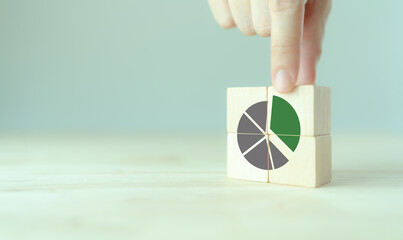 Growing green business market concept. Increase market share, growth of business profit. Market penetration and expansion strategies. Wooden cubes showing a market share percentage using a pie chart.