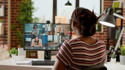 Businesswoman using online videocall conference to talk to colleagues, chatting on remote...