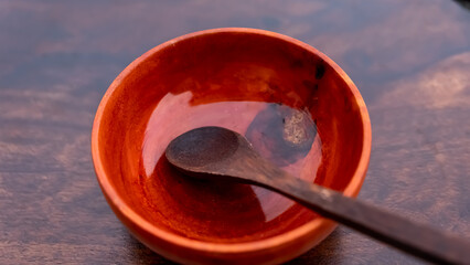 Wooden Bowl and Wooden Spoon isolated on brown background. Empty wooden dish and spoon
