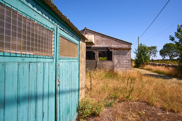 Fototapeta na wymiar Abandoned farm buildings on a sunny day