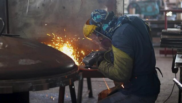 Worker polishing in metal industry