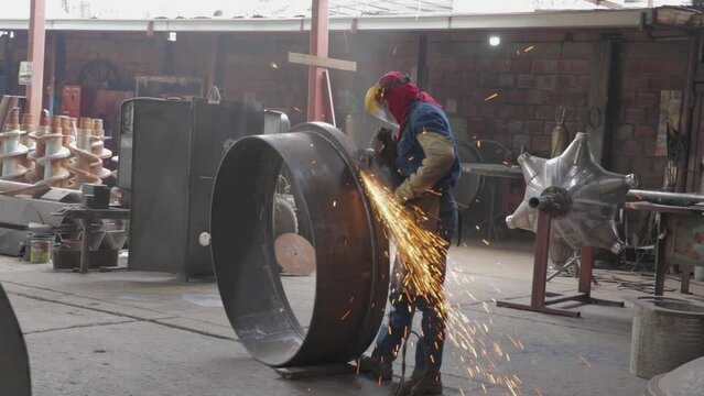 Worker polishing a ring in metal industry medium plane