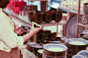 Close up woman hand choosing side dish bowl or small bowl in home store for kitchen and lifestyle concepts.