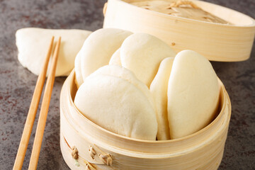 Gua bao, Bao bread in bamboo steamer closeup on the table. Horizontal