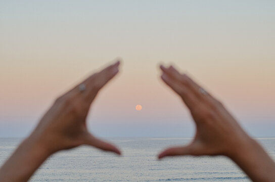 Full Moon moonrise between hands Sunshine Beach Noosa Heads Australia supermoon 