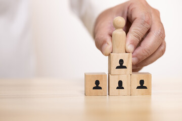 Hand place wooden blocks set to organization chart with people icon. Concept for company and human...
