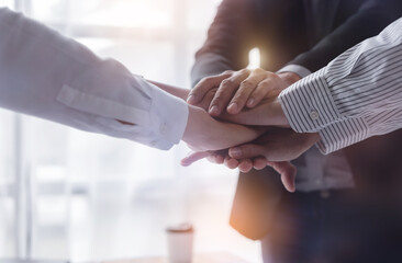 Obraz premium Business team standing hands together, Volunteer charity work. People join for cooperation success business. Panoramic teamwork business joins hand together concept,