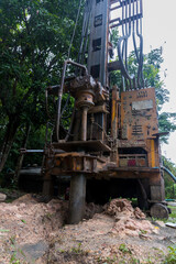 Fototapeta na wymiar Ground water hole drilling machine installed on the old truck. Ground water drilling machine installed in rural