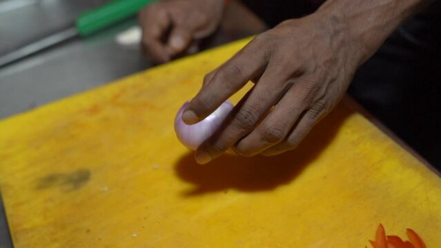 one man taking a onian for cutting